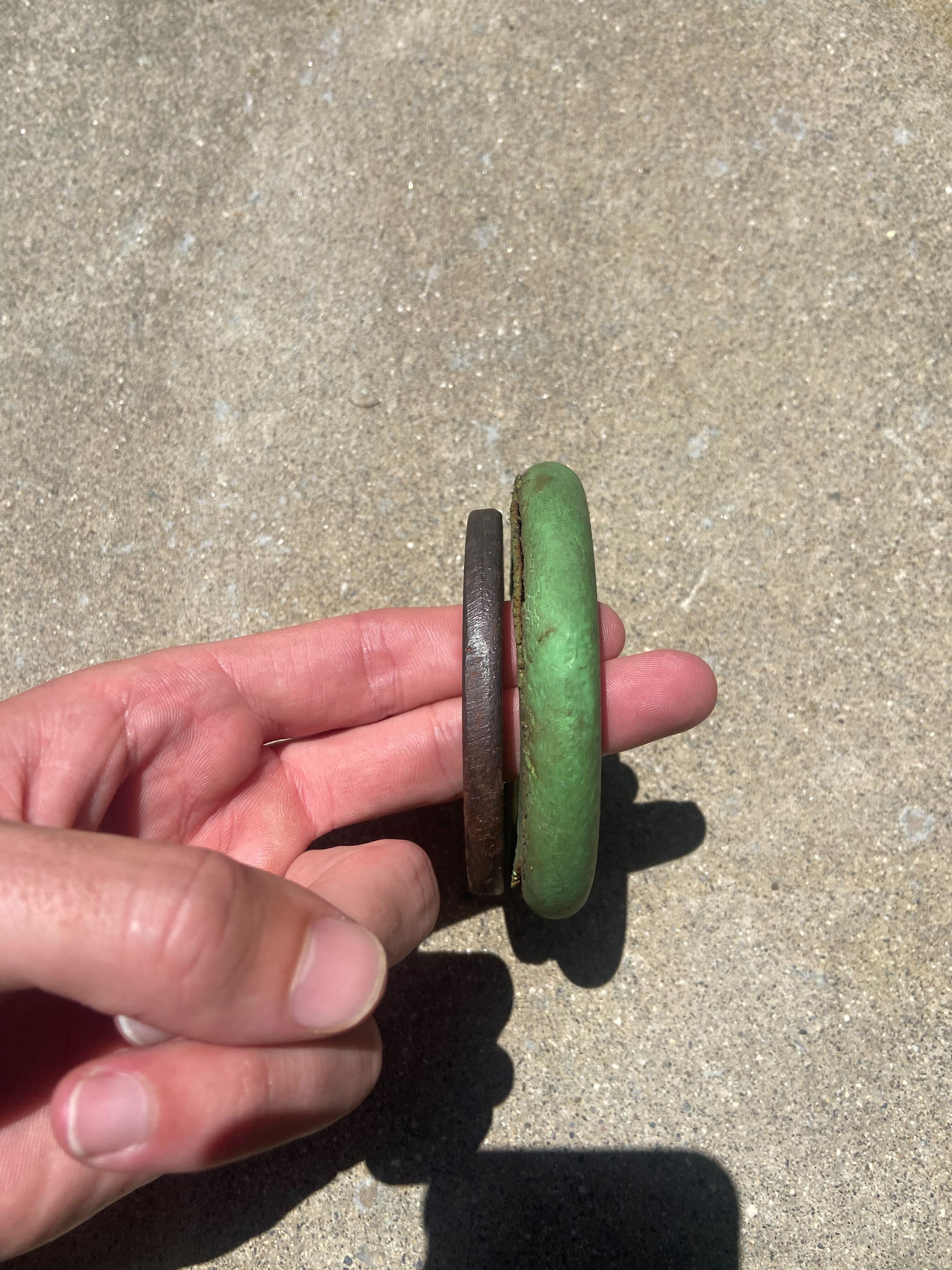 Side profile of a Chuckers ring held in hand showing its low-profile shape.